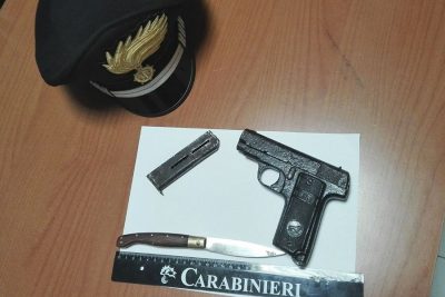 La pistola e il coltello trovato al 63enne durante la perquisizione